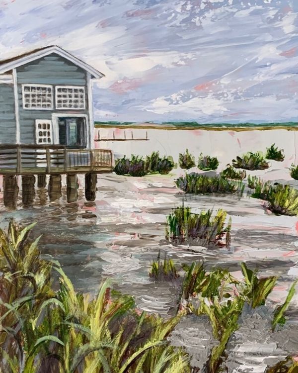 Watercolor painting of a blue boathouse on stilts over a salt marsh